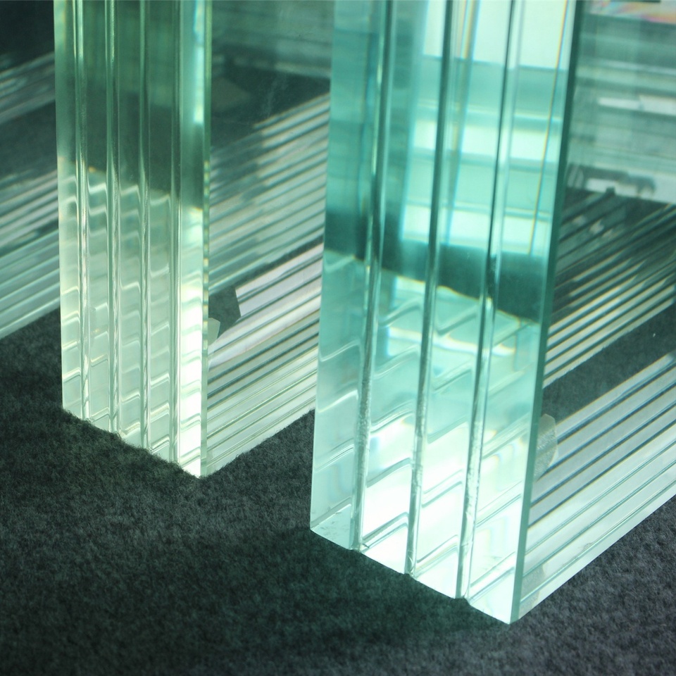 Thick glass panels showing green-tinted edges for pool material comparison